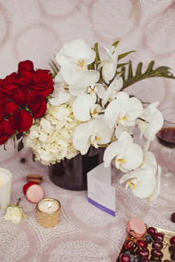 Alba, orquídeas con rosas rojas.